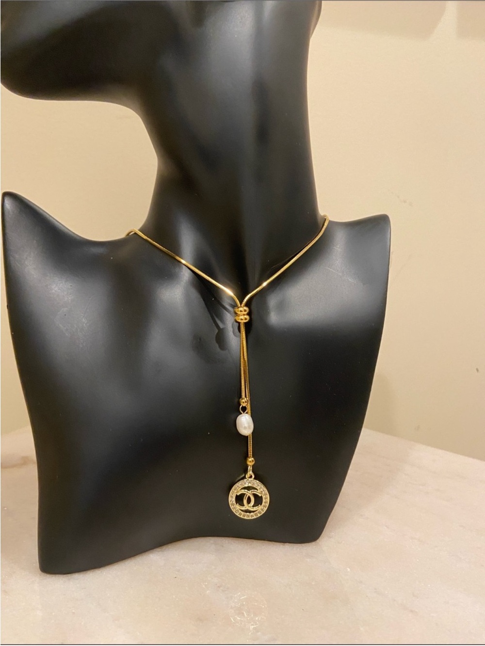 Elegant Gold-Tone Lariat Necklace with Pearl and Chanel Charm